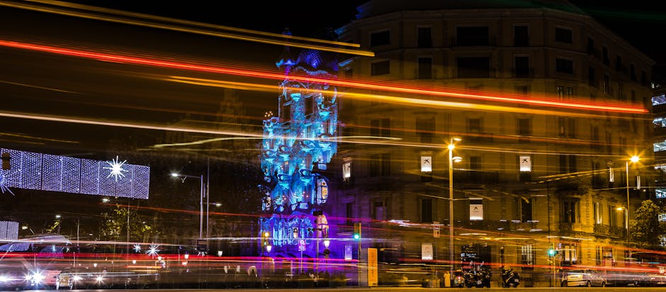 Long-exposure shot of Casa Batlló in Barcelona adorned with festive lights during night.